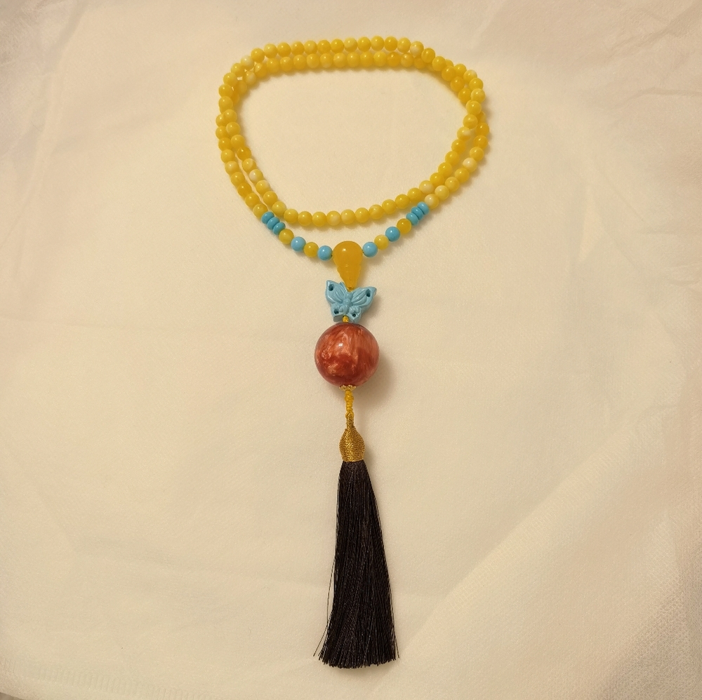 Amber long necklace with turquoise pendant.